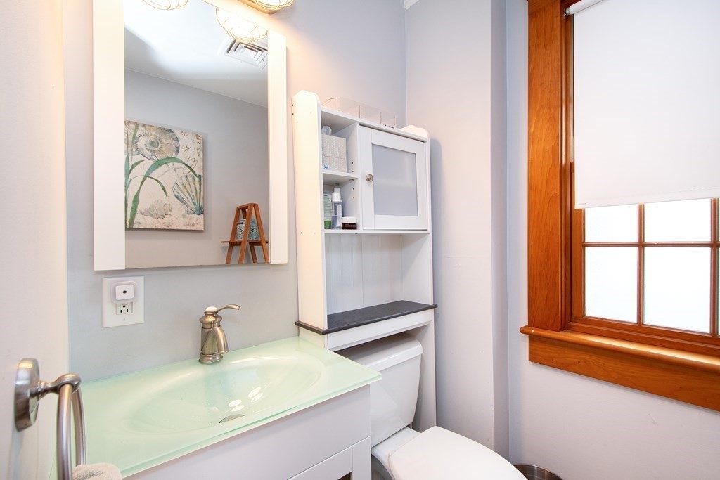6 Oceanside Drive Scituate, MA 02066 - Photo 28 of 34 a bathroom with a sink toilet and mirror