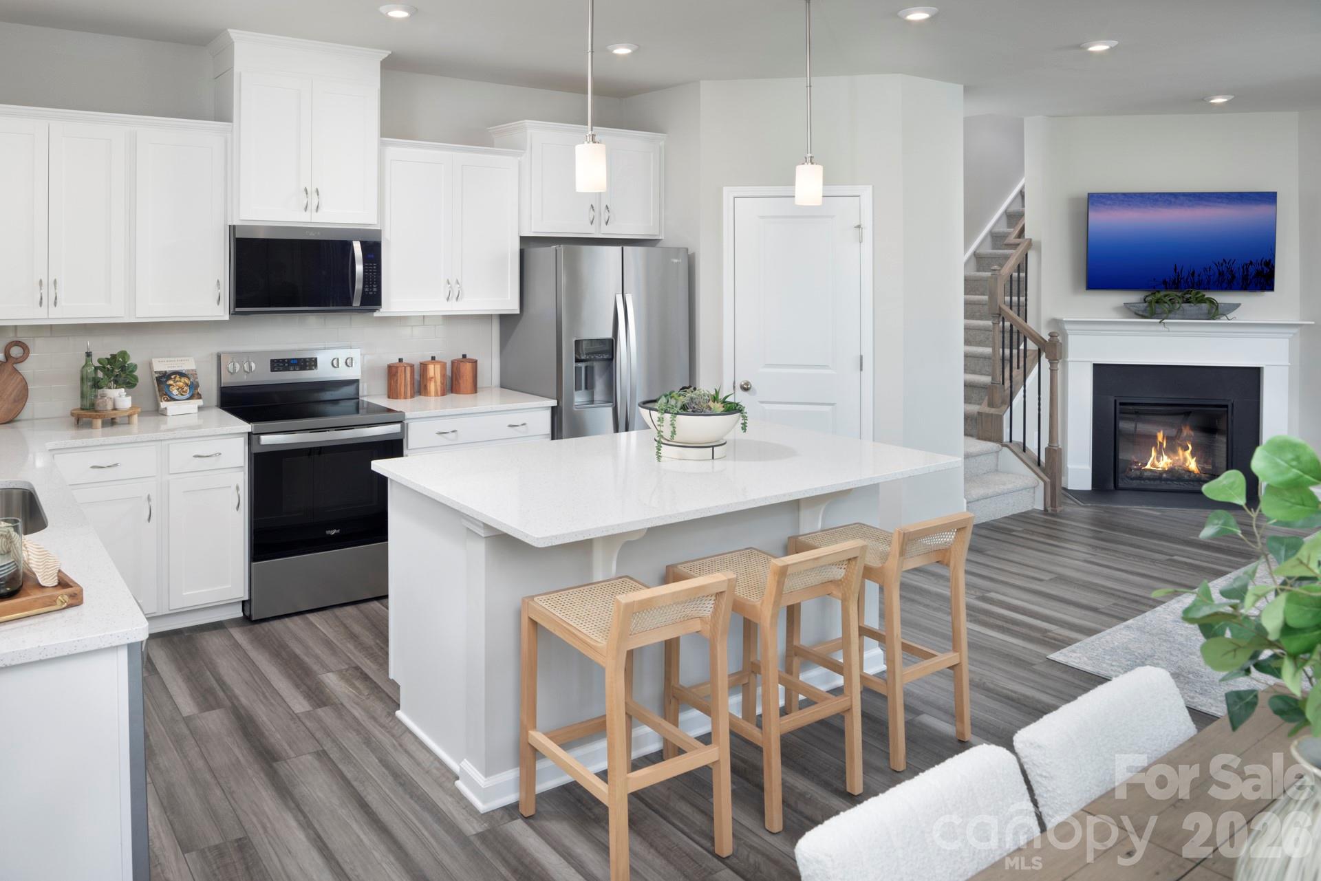 344 Laura Elizabeth Lane Clover, SC 29710 - Photo 5 of 19 a kitchen with stainless steel appliances granite countertop a kitchen island hardwood floor sink stove and microwave