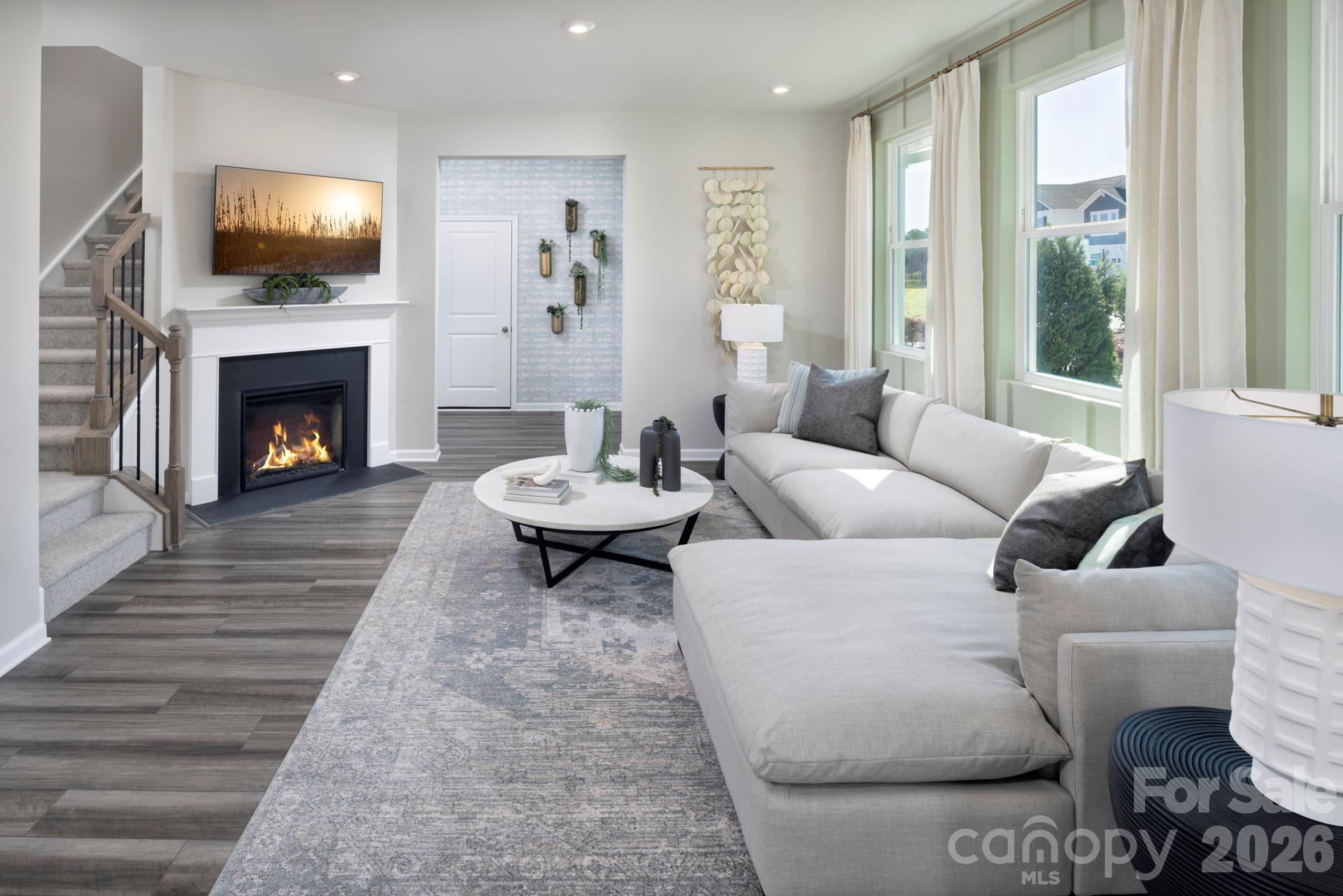 344 Laura Elizabeth Lane Clover, SC 29710 - Photo 7 of 19 a living room with furniture a flat screen tv and a fireplace