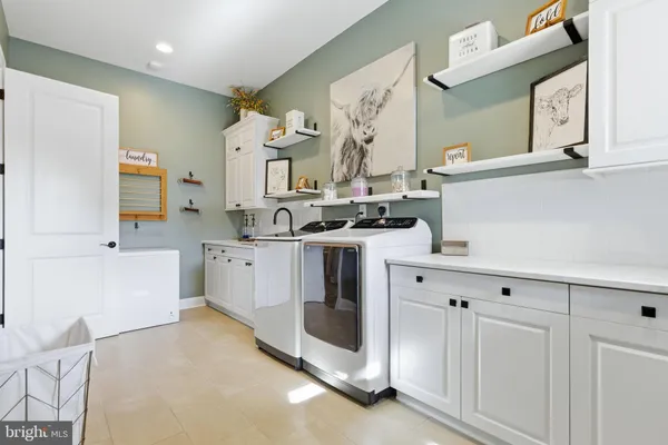 a view of cabinets a sink a window and a potted plant