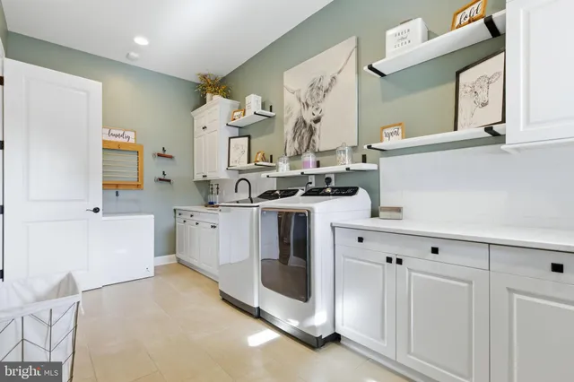 a view of cabinets a sink a window and a potted plant