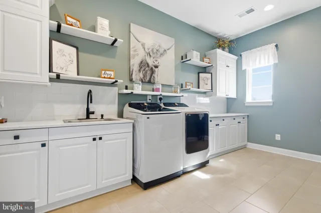 a spacious bedroom with a bed and a chandelier