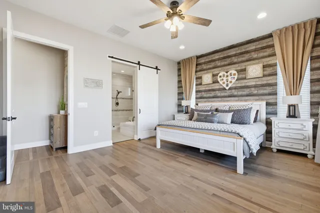 a spacious bedroom with a large bed and a large window