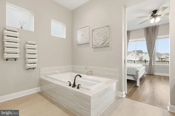 a bathroom with a bathtub sink and mirror