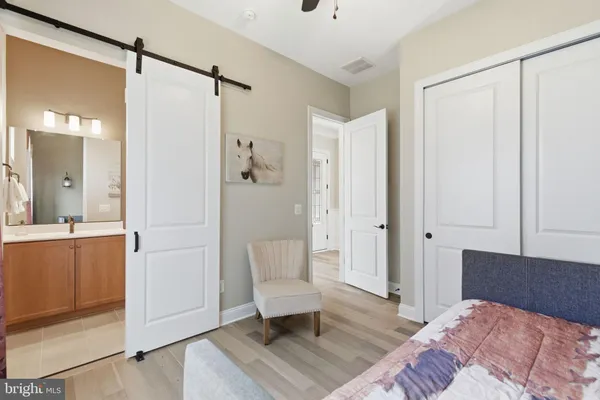 a bedroom with a bed and a painting on the wall