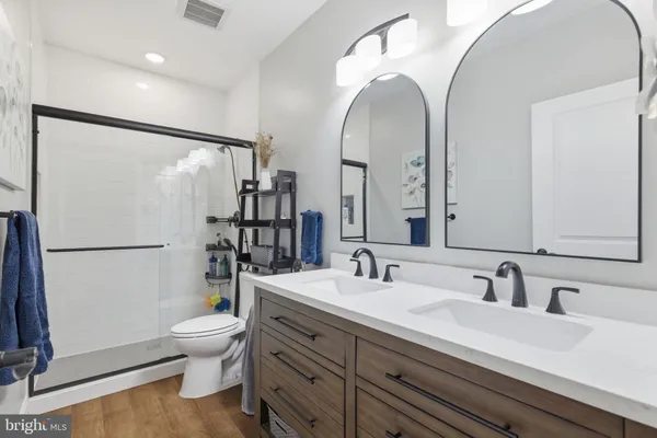 a kitchen with stainless steel appliances granite countertop a sink and a refrigerator