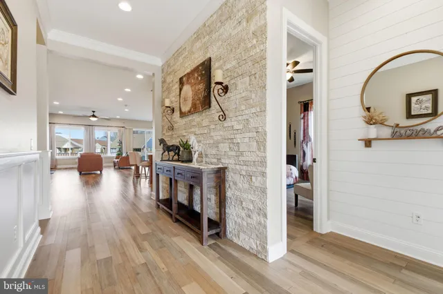 a living room with lots of furniture and a wooden floor