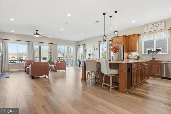 a large kitchen with a table and refrigerator
