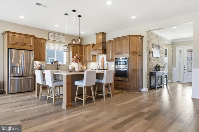 a view of a kitchen counter space dining table and chairs