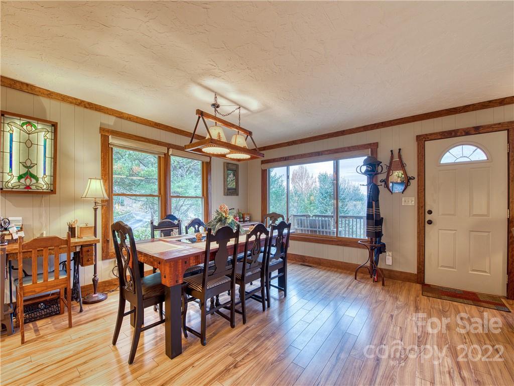 365 Old Country Road Waynesville, NC 28786 - Photo 8 of 34 a view of a dining room with furniture window and wooden floor