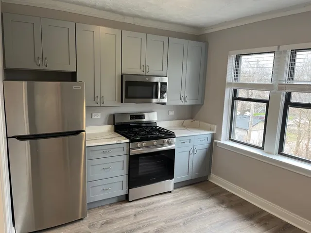 a kitchen with a refrigerator stove and microwave