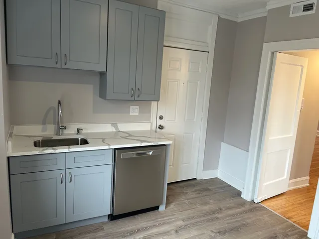 a kitchen with a sink and cabinets