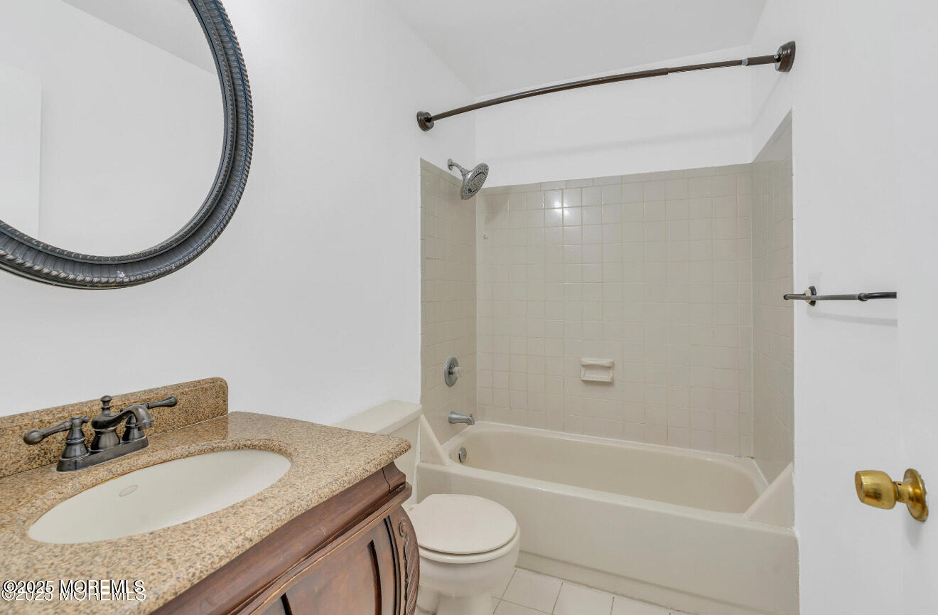 115 Leesville Road Jackson, NJ 08527 - Photo 13 of 15 a bathroom with a granite countertop sink a toilet and a mirror