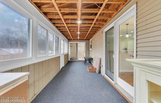 a view of a large room with wooden floor and windows
