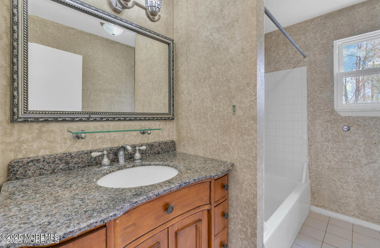 115 Leesville Road Jackson, NJ 08527 - Photo 8 of 15 a bathroom with a granite countertop sink and a mirror