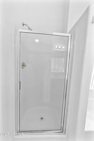 a bathroom with a glass shower door