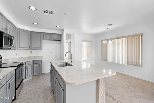 a kitchen with a sink stove and cabinets
