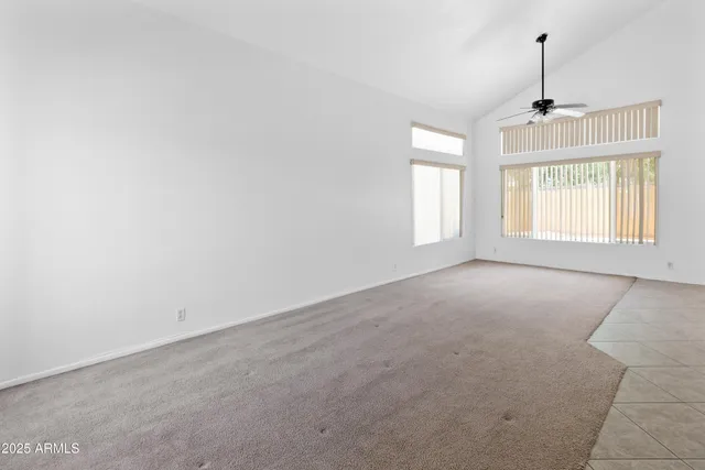 an empty room with windows and cabinet