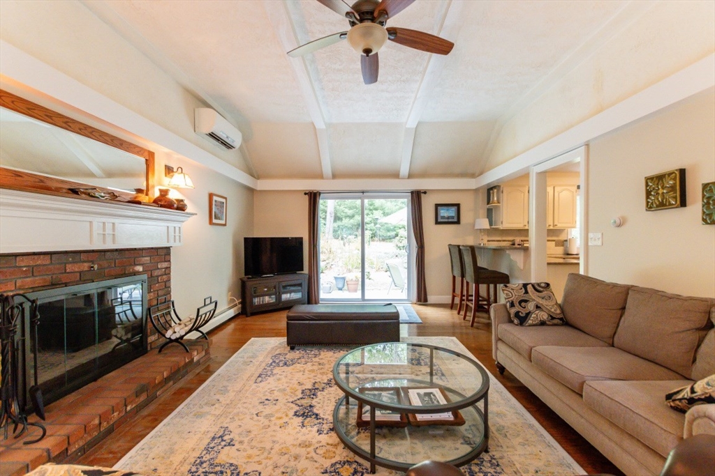 64 Wayside Inn Road Marlborough, MA 01752 - Photo 11 of 42 a living room with furniture a fireplace and a flat screen tv