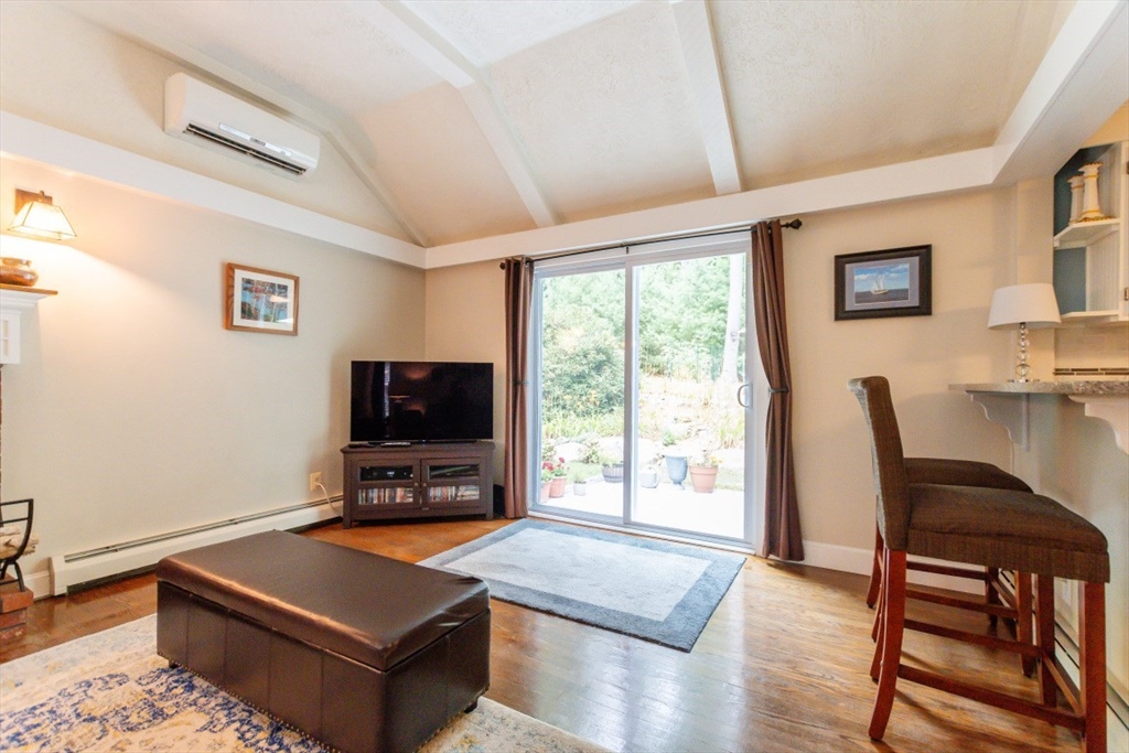 64 Wayside Inn Road Marlborough, MA 01752 - Photo 15 of 42 a living room with furniture a flat screen tv and a large window
