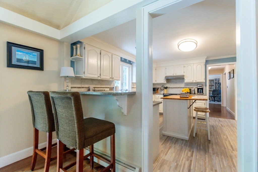64 Wayside Inn Road Marlborough, MA 01752 - Photo 16 of 42 a kitchen with stainless steel appliances kitchen island granite countertop a dining table chairs and a refrigerator
