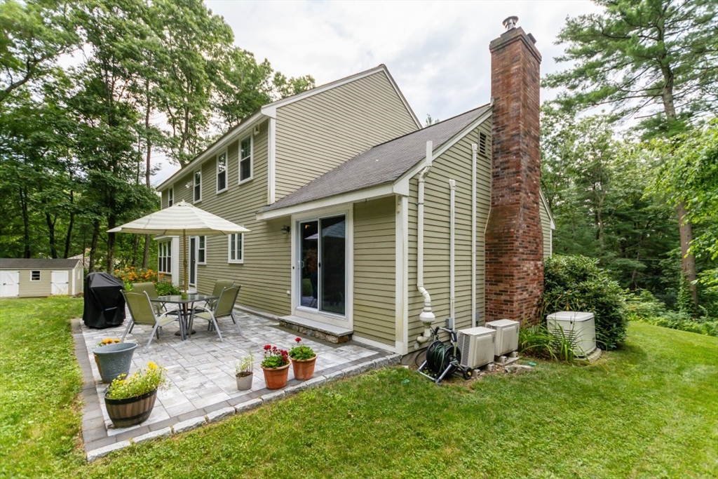 64 Wayside Inn Road Marlborough, MA 01752 - Photo 6 of 42 a view of a house with backyard sitting area and garden