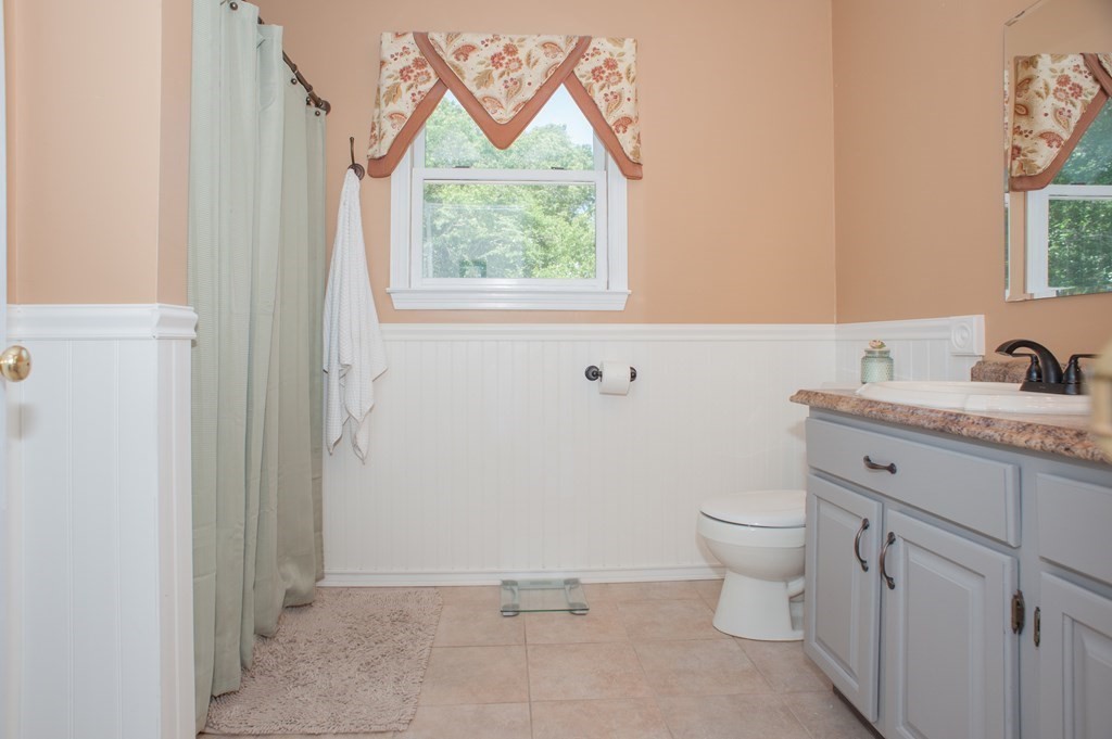 53 Armsby Road Sutton, MA 01590 - Photo 20 of 42 a bathroom with a granite countertop sink mirror vanity and toilet