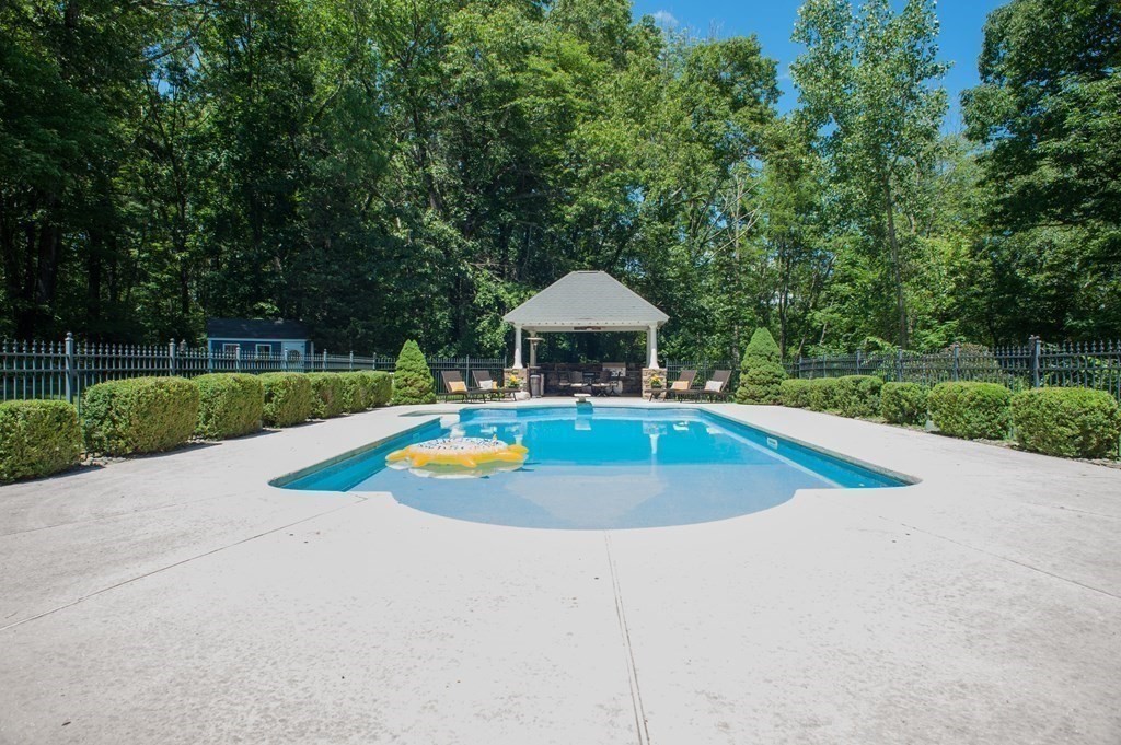 53 Armsby Road Sutton, MA 01590 - Photo 33 of 42 a view of a swimming pool with a yard and large trees