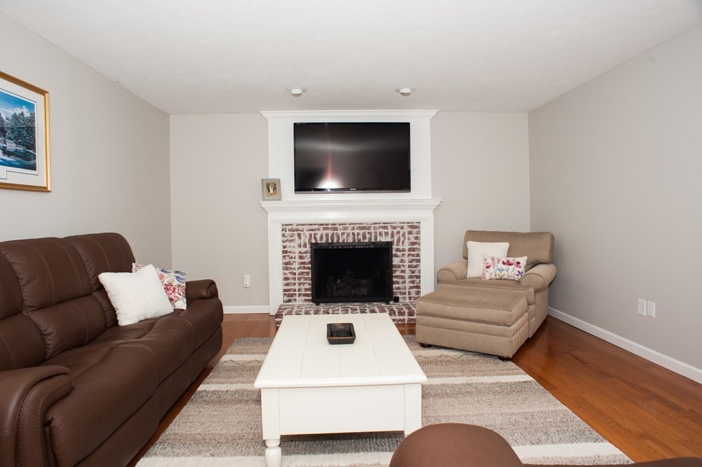 53 Armsby Road Sutton, MA 01590 - Photo 8 of 42 a living room with furniture and a flat screen tv