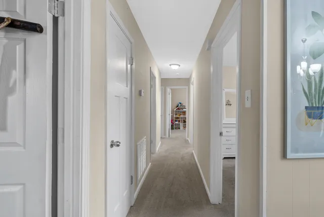 a view of a hallway with wooden floor