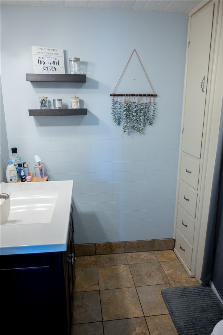 3365 Trapping Brook Road Wellsville, NY 14895 - Photo 23 of 47 The full bathroom is well-appointed and has a large built-in cabinet and drawers.
