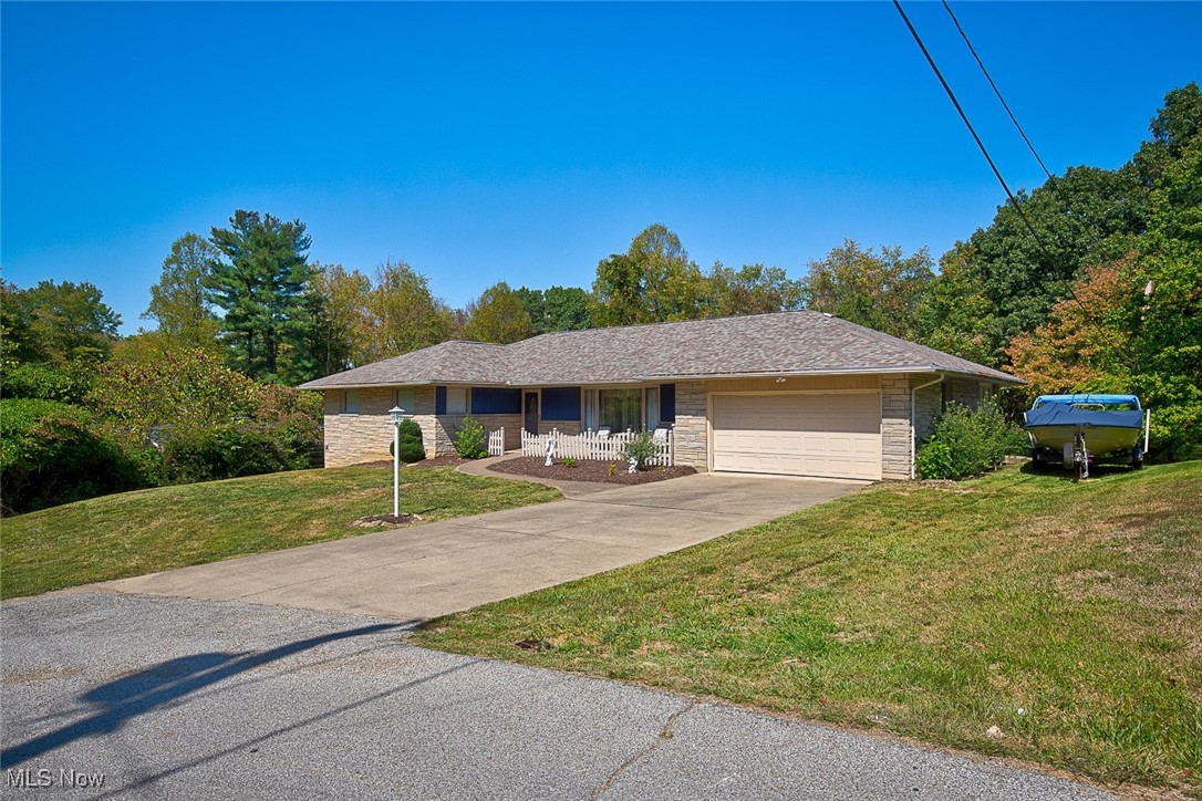 8813 Clinton Road Cambridge, OH 43725 - Photo 2 of 28 Ranch-style house featuring a garage and a front lawn