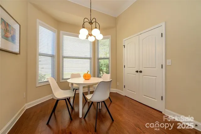a view of a dining room with furniture wooden floor and chandelier
