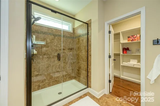 a bathroom with a glass shower door