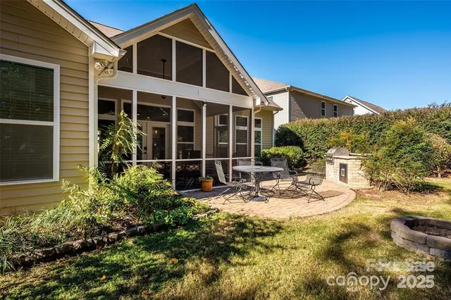 a view of a house with backyard and sitting area
