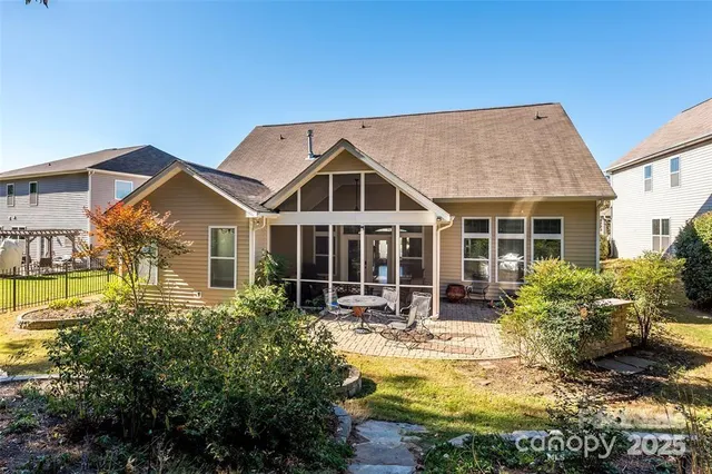 a view of a house with swimming pool and chairs