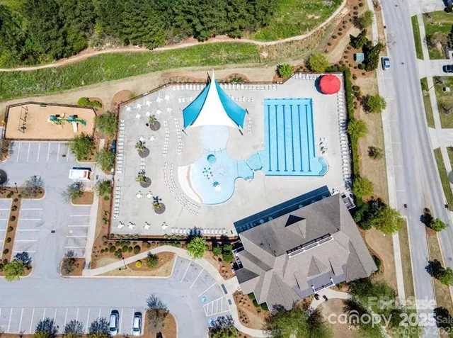 an aerial view of a house with a swimming pool and outdoor seating