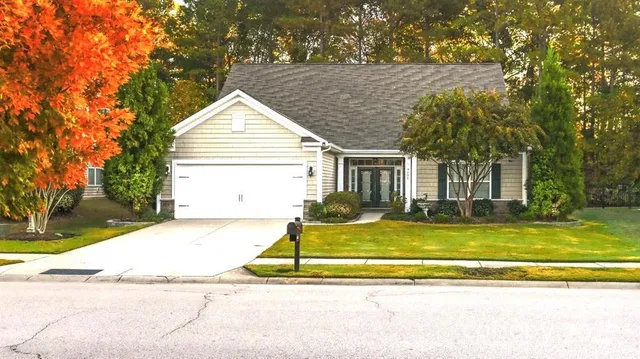 a view of a house with a swimming pool and sitting area