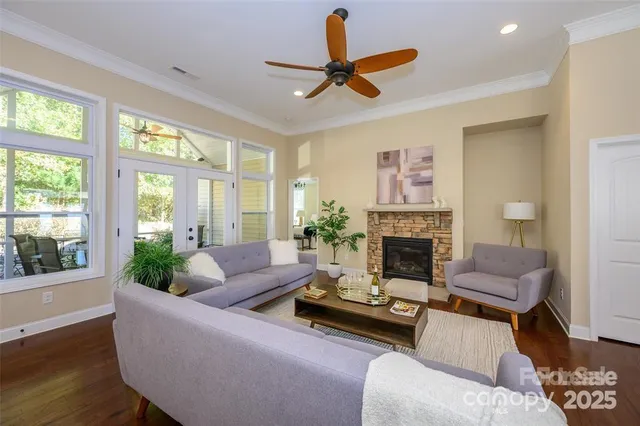 a living room with furniture a fireplace and a large window