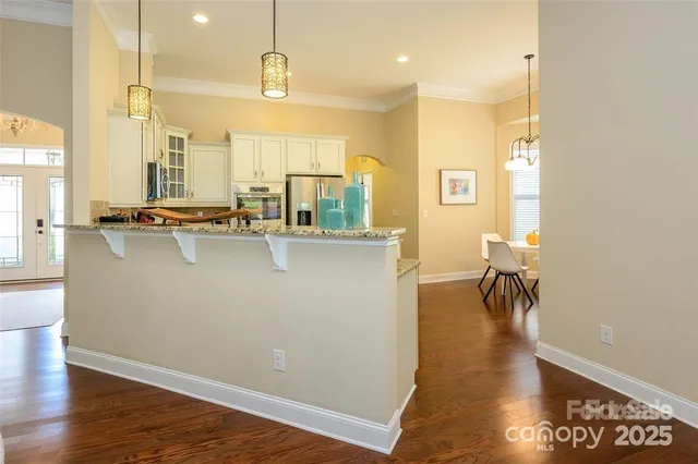 a view of a kitchen counter space and wooden floor