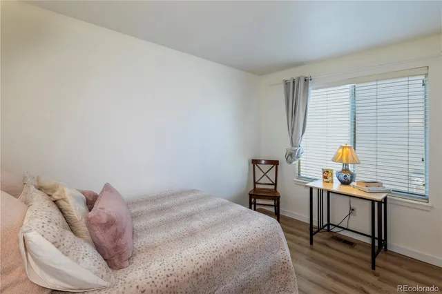 a bedroom with a bed and a desk