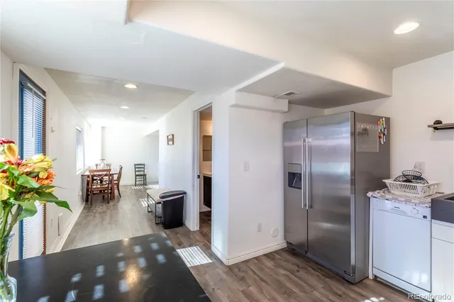 a kitchen with granite countertop a sink stainless steel appliances and cabinets