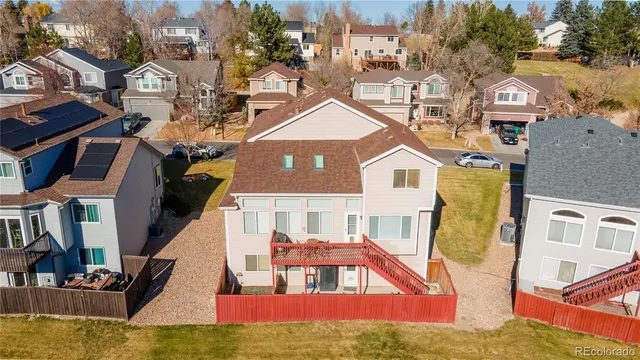 a view of a house with wooden deck and furniture