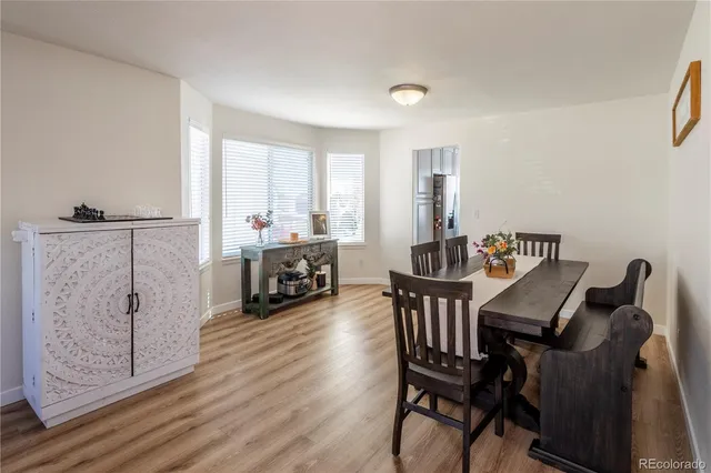a view of a dining room with furniture and wooden floor