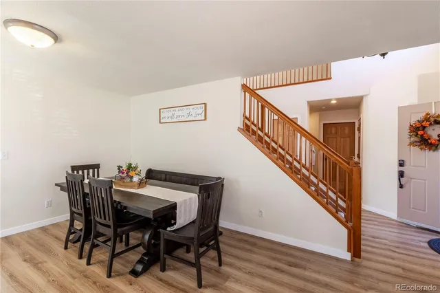 a view of a dining room with furniture and wooden floor