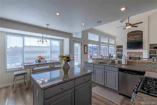 a kitchen with a sink appliances and cabinets