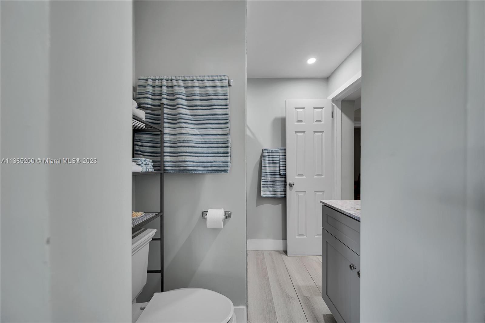 615 Southwest 21st Road Miami, FL 33129 - Photo 11 of 43 a bathroom with a toilet a sink and mirror