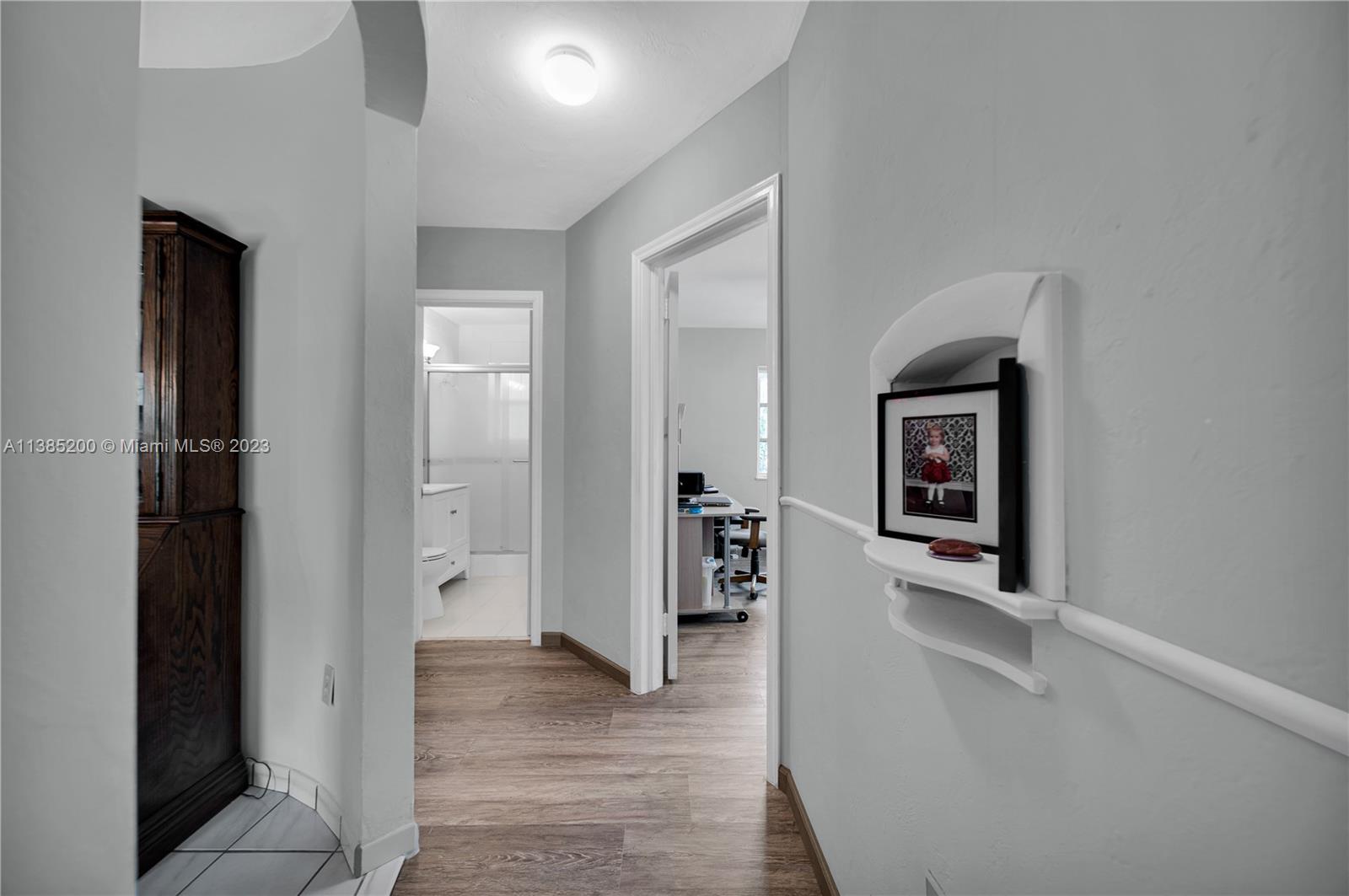 615 Southwest 21st Road Miami, FL 33129 - Photo 13 of 43 a view of a hallway with wooden floor and a living room