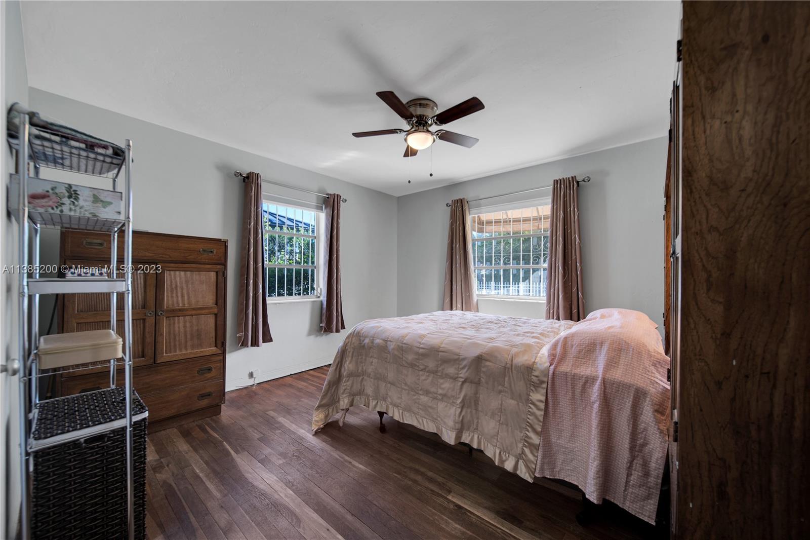 615 Southwest 21st Road Miami, FL 33129 - Photo 20 of 43 a bedroom with a bed closet and wooden floor