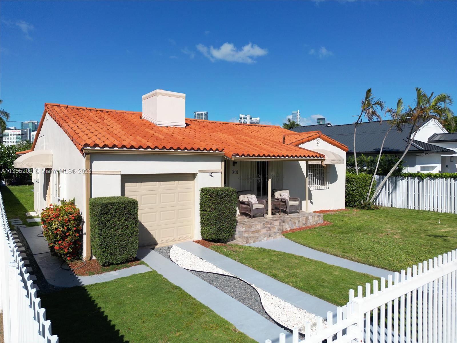 615 Southwest 21st Road Miami, FL 33129 - Photo 2 of 43 a front view of a house with garden